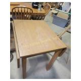 Oak drop-leaf table with simple, classic design.