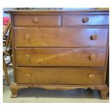 wooden dresser with four drawers, featuring