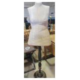 dress form on an adjustable metal stand with a