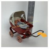 Wyandotte style doll and press steel buggy.