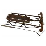 Wooden sled. Serrated grass whip with wooden