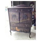 Wood dresser with ornate carved details