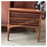 A mid-century modern wooden nightstand with two