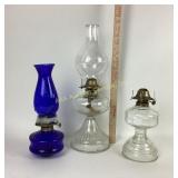 Clear glass and cobalt blue oil lamps blue