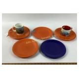 Orange and blue plates, Starbucks coffee mugs.