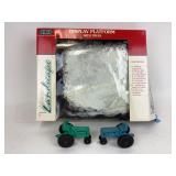 Auburn rubber toy tractors. Display platform