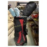 2 sets of golf clubs with bags