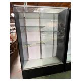 Black-framed glass display case with shelves
