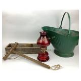 red oil lamp, rake, and garden accessories