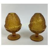 Amber-colored glass candleholders with floral desi