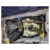 Storage bin with electrical cords, gloves, and ass