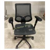 Black mesh swivel office chair with armrests