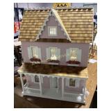 Pink dollhouse with furniture and electrical wirin