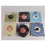 Assorted 45 RPM records with sleeves