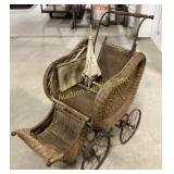 Antique wicker baby carriage with parasol