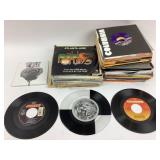 Assorted 7-inch vinyl records with sleeves