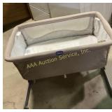 Chicco beige portable bassinet with adjustable fra