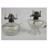 Pair of clear glass oil lamps with metal burners