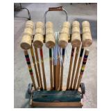 Croquet set with wooden mallets, balls, and wheele