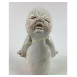 White Ceramic Figurine With Crying Expression