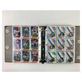 Football cards, organized by team in a binder:
