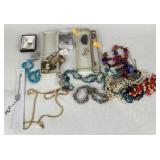 Costume jewelry: jade stick pin, brooches.