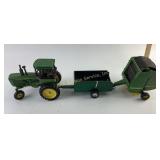 John Deere metal tractor with pull behind round