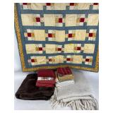 Pile of textiles including two throw blankets,