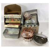Cookbooks and a variety of kitchen pans and