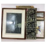Stack of wall art of various styles including