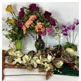 Glass pitcher vase, wooden bow saw, faux orchids