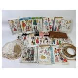 Baby doll patterns, embroidery hoops, scissors. G