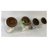 Glass jars with wooden lid: 2 large and 2 small.