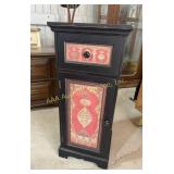 Black accent cabinet with ï¿½La Decoration Arabeï¿½