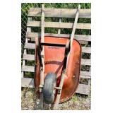 Steel wheelbarrow with wooden handled. Some rust