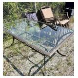 Outdoor glass top table with 6 chairs. 28 in tall