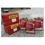 Five gas cans : 3 metal Coleman and 2 flat metal