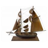 Wooden model ship with wooden sails, broken sail