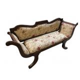 Carved wooden settee with floral pattern