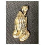 Sterling praying hands pendant with white stones.