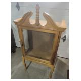 Small Wooden Display Or Curio Cabinet Featuring A