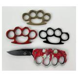 Metal Knuckle style paperweights, one with knife