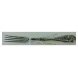 Early sterling silver handled fork, dent