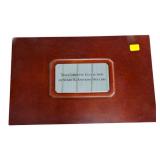 Set of SBA dollars in a wood display case,