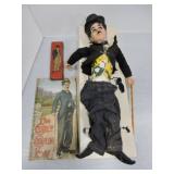 Charlie Chaplin doll, book, and pencil tin