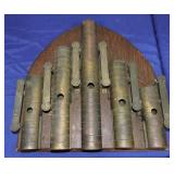 Set of heavy antique brass chimes mounted on