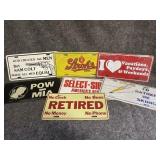 Several custom license plates, most are metal but