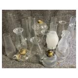 Several glass covers for oil lamps and 3 oil