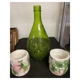 Vintage green bottle with design at bottom