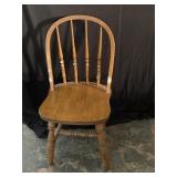 Oak dining chair has some white paint on it